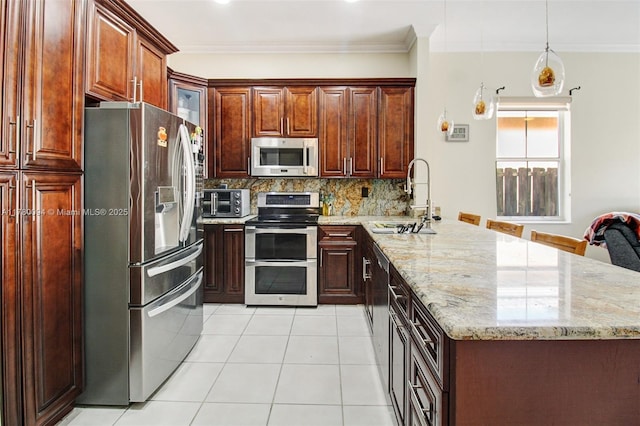 kitchen with tasteful backsplash, a peninsula, light tile patterned flooring, stainless steel appliances, and a sink