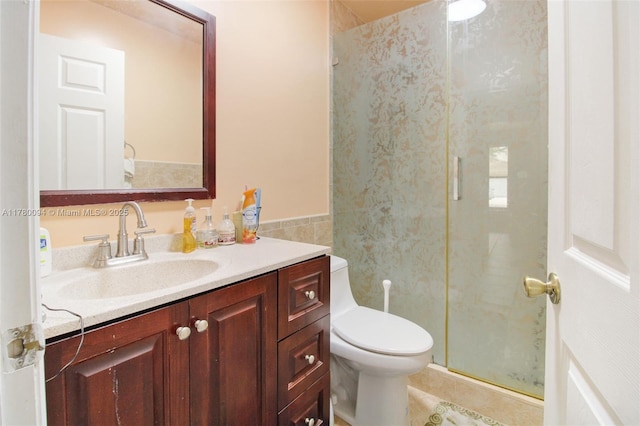 full bathroom featuring a shower stall, vanity, toilet, tile walls, and tile patterned floors