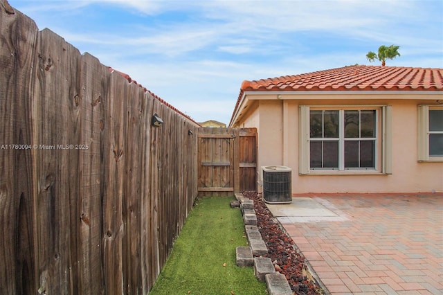 view of yard with cooling unit, a patio, and a fenced backyard