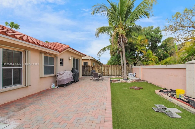 view of yard with a patio area and a fenced backyard