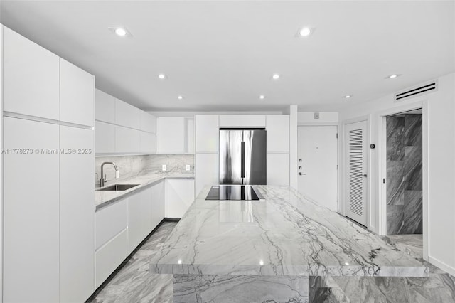 1658 Bay Rd Unit 504, Miami Beach, FL 33139 - kitchen with a sink, visible vents, freestanding refrigerator, and modern cabinets