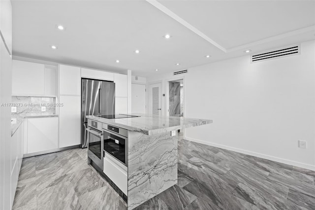 1658 Bay Rd Unit 504, Miami Beach, FL 33139 - kitchen featuring visible vents, white cabinets, modern cabinets, stainless steel appliances, and marble finish floor