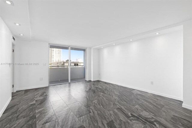 1658 Bay Rd Unit 504, Miami Beach, FL 33139 - empty room featuring marble finish floor, baseboards, and recessed lighting