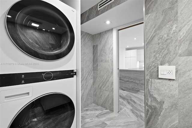 1658 Bay Rd Unit 504, Miami Beach, FL 33139 - laundry area with stacked washing maching and dryer, visible vents, marble finish floor, and laundry area