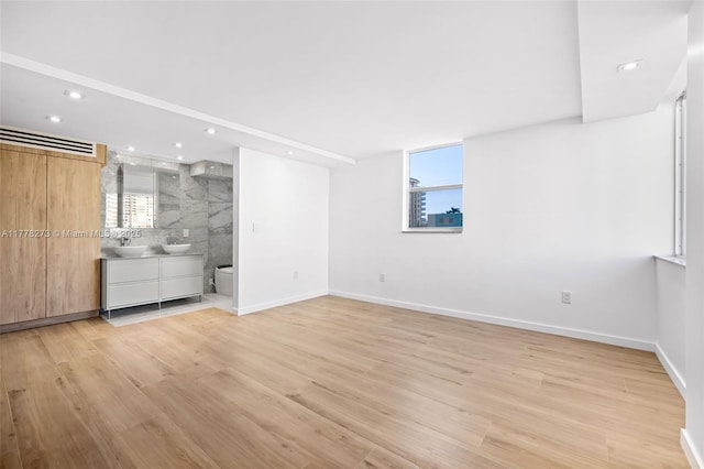 1658 Bay Rd Unit 504, Miami Beach, FL 33139 - unfurnished bedroom featuring baseboards, light wood-type flooring, and recessed lighting