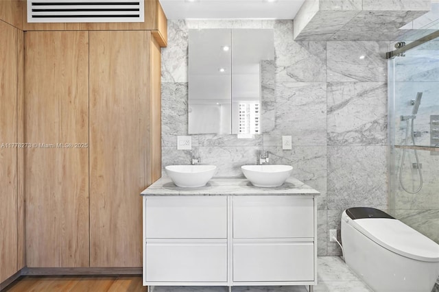 1658 Bay Rd Unit 504, Miami Beach, FL 33139 - full bath featuring a stall shower, double vanity, a sink, and tile walls