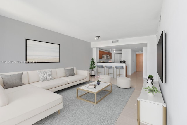 living room with visible vents and light wood finished floors