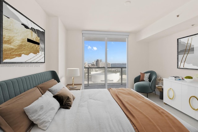 bedroom with a city view and access to exterior