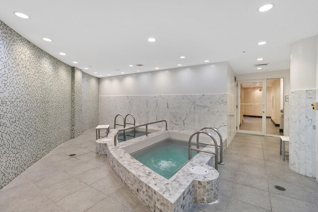 view of pool with an indoor hot tub