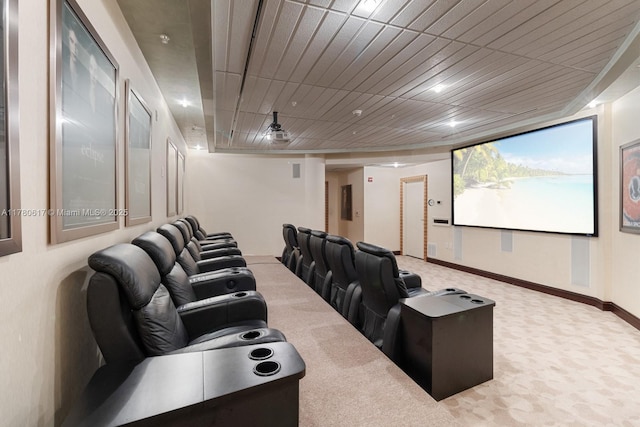 carpeted home theater room with baseboards