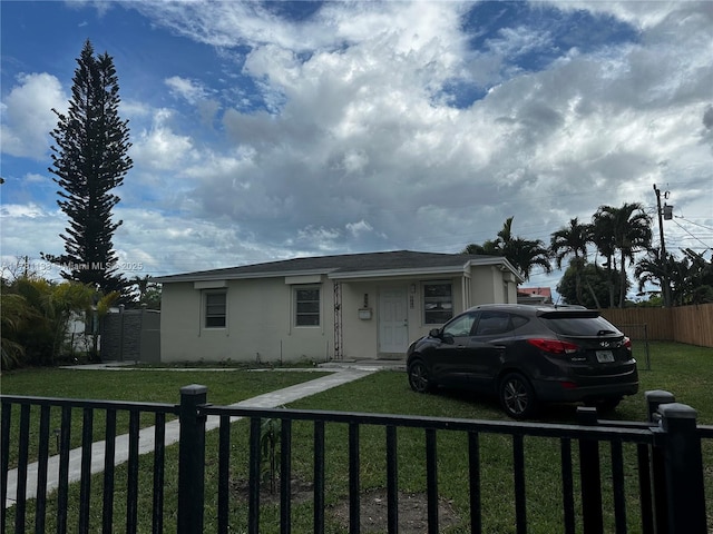 7540 SW 37th St, Miami, FL 33155 - view of front facade with stucco siding, a front lawn, and a fenced front yard