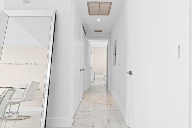 hallway featuring baseboards, visible vents, recessed lighting, and marble finish floor