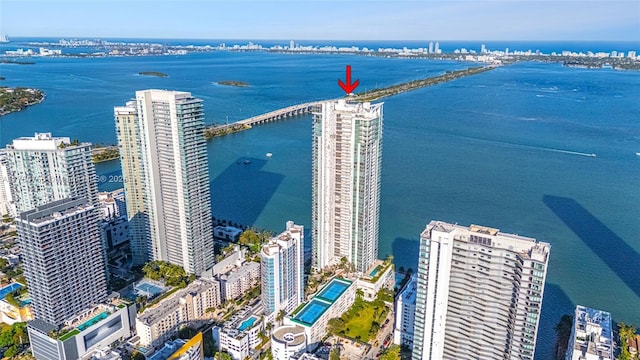 birds eye view of property featuring a city view and a water view