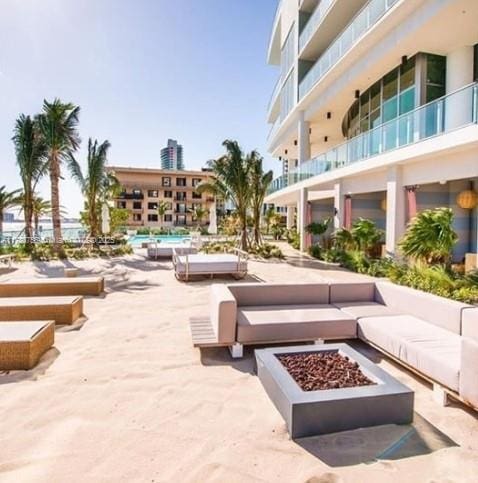 view of home's community featuring a fire pit and a patio