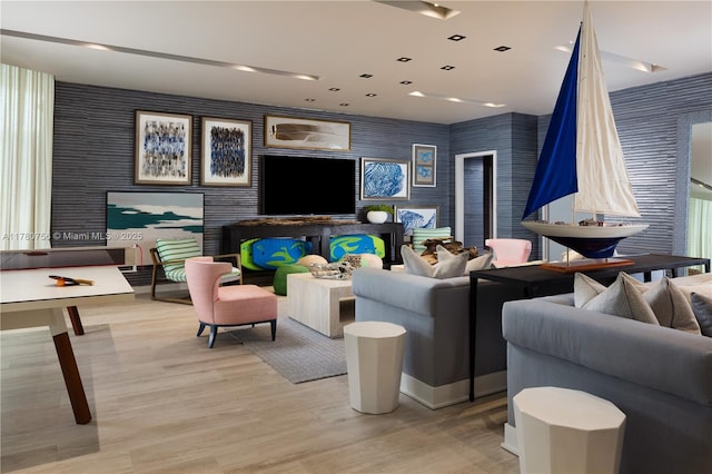 living area with wallpapered walls and wood finished floors