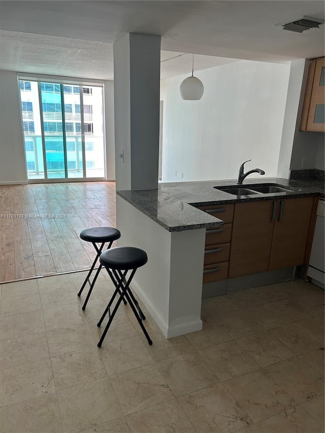2101 Brickell Ave Unit 502, Miami, FL 33129 - kitchen with a peninsula, dark stone counters, and dishwasher