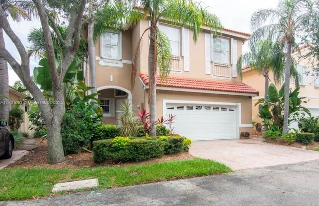 1410 Sweetbay Way, Hollywood, FL 33019 - view of front facade featuring stucco siding, driveway, an attached garage, and a tiled roof