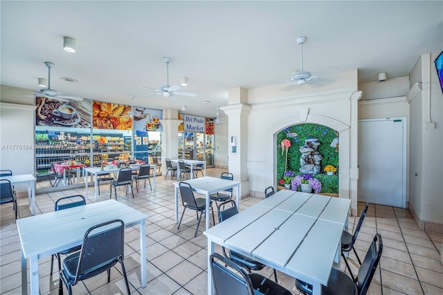 dining room featuring light tile patterned floors, ceiling fan, and decorative columns