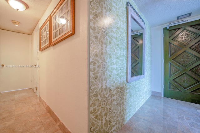 corridor with a textured ceiling
