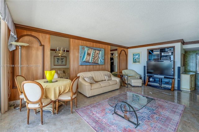 living area featuring wood walls, a textured ceiling, and crown molding