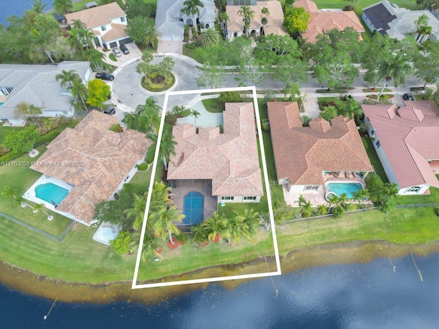 drone / aerial view with a water view and a residential view