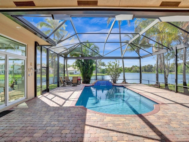 pool featuring a water view, a patio, and glass enclosure