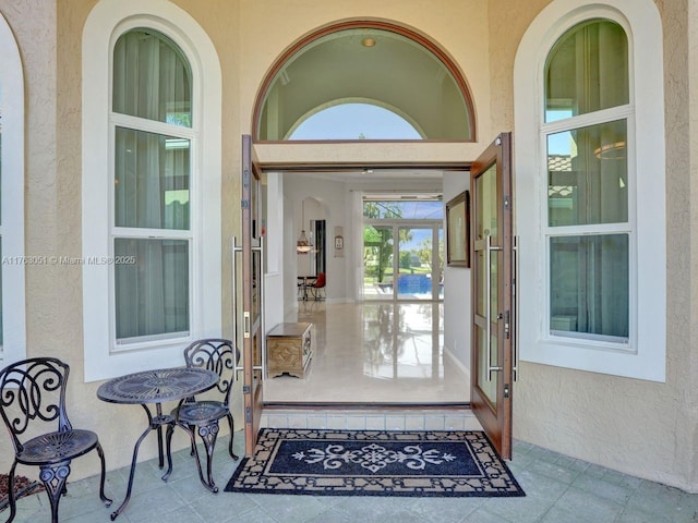 entrance to property featuring stucco siding