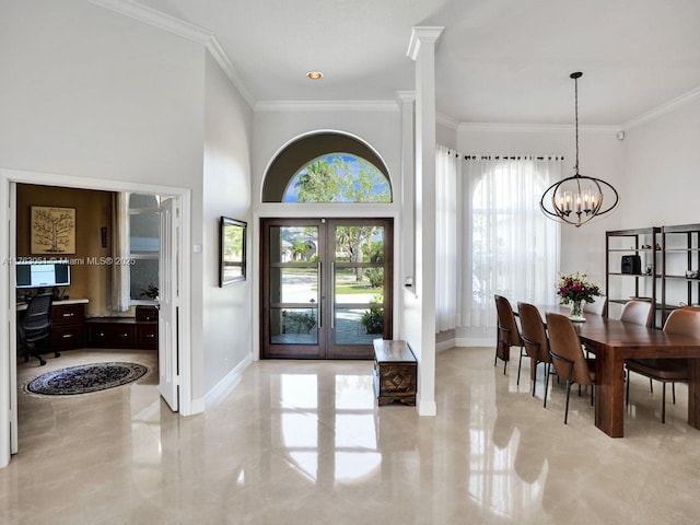 foyer entrance featuring crown molding, baseboards, and a chandelier