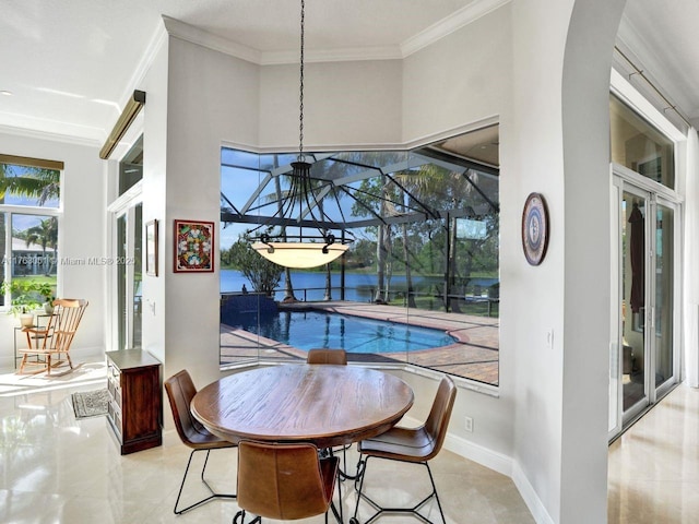dining area with crown molding, baseboards, tile patterned flooring, and arched walkways