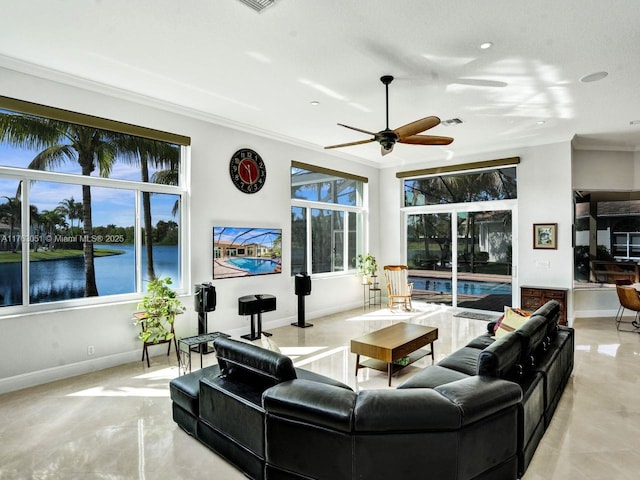 living area featuring plenty of natural light, baseboards, a ceiling fan, and ornamental molding