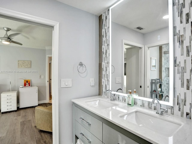 bathroom featuring visible vents, a sink, a ceiling fan, and wood finished floors