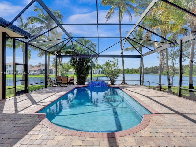 outdoor pool with a water view, a patio, and a lanai