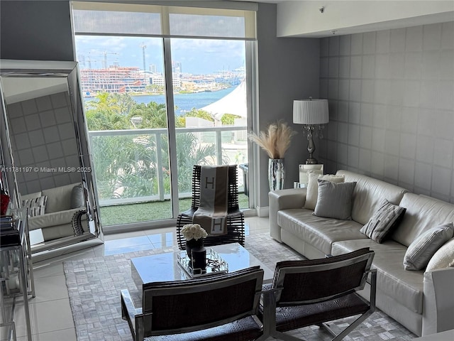 253 NE 2nd St Unit 1003, Miami, FL 33132 - tiled living area with tile walls, a view of city, a wall of windows, and a water view