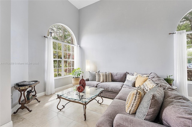 1008 NW 116th Ave, Coral Springs, FL 33071 - living room featuring healthy amount of natural light, high vaulted ceiling, and light tile patterned floors