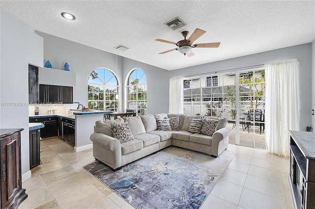 1008 NW 116th Ave, Coral Springs, FL 33071 - living area featuring ceiling fan, light tile patterned floors, and a textured ceiling