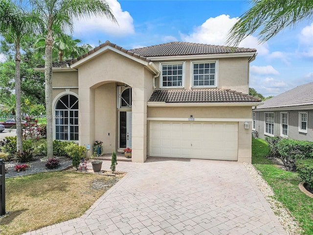 1008 NW 116th Ave, Coral Springs, FL 33071 - mediterranean / spanish home featuring a tile roof, stucco siding, and decorative driveway