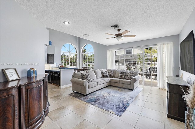 1008 NW 116th Ave, Coral Springs, FL 33071 - living room featuring a ceiling fan, light tile patterned floors, and a textured ceiling