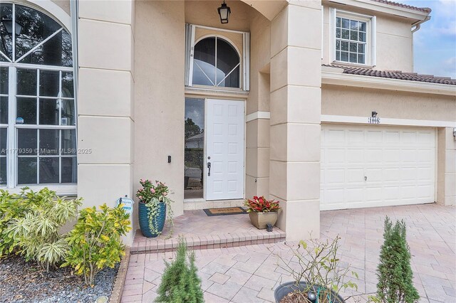 1008 NW 116th Ave, Coral Springs, FL 33071 - doorway to property with a garage, stucco siding, driveway, and a tiled roof