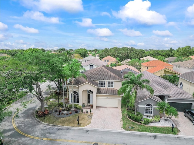 1008 NW 116th Ave, Coral Springs, FL 33071 - view of front of home with a tiled roof, driveway, stucco siding, and a residential view