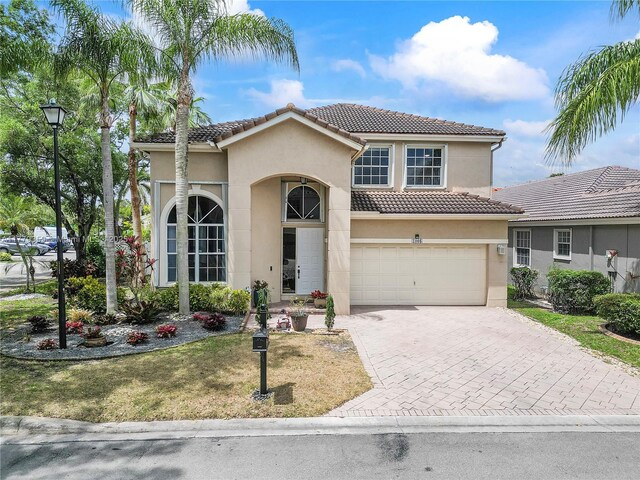 1008 NW 116th Ave, Coral Springs, FL 33071 - mediterranean / spanish home with stucco siding, a tiled roof, driveway, a garage, and a front lawn