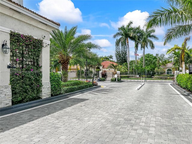 1008 NW 116th Ave, Coral Springs, FL 33071 - view of street featuring a gate, curbs, and a gated entry