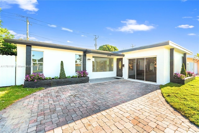 back of property featuring a patio and fence
