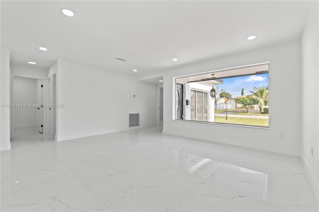 spare room with recessed lighting, visible vents, and marble finish floor
