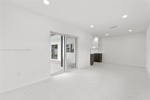 unfurnished room with visible vents, baseboards, recessed lighting, and marble finish floor
