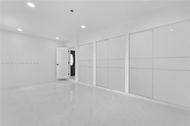 interior space with marble finish floor and recessed lighting