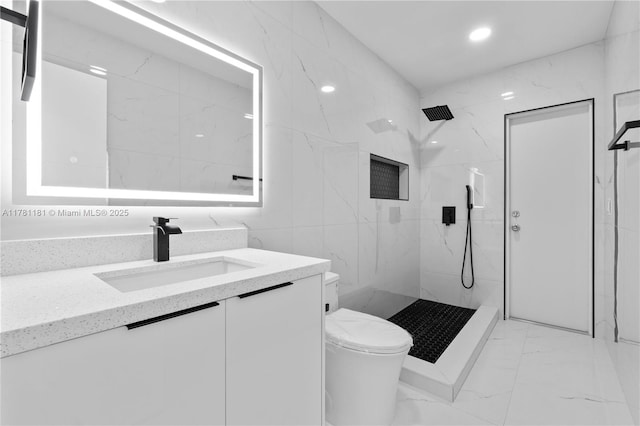 full bath featuring vanity, toilet, marble finish floor, tile walls, and a marble finish shower