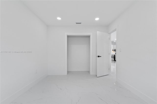 interior space featuring recessed lighting, marble finish floor, baseboards, and visible vents