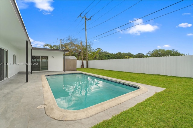 view of swimming pool featuring a patio, a fenced backyard, a fenced in pool, and a lawn