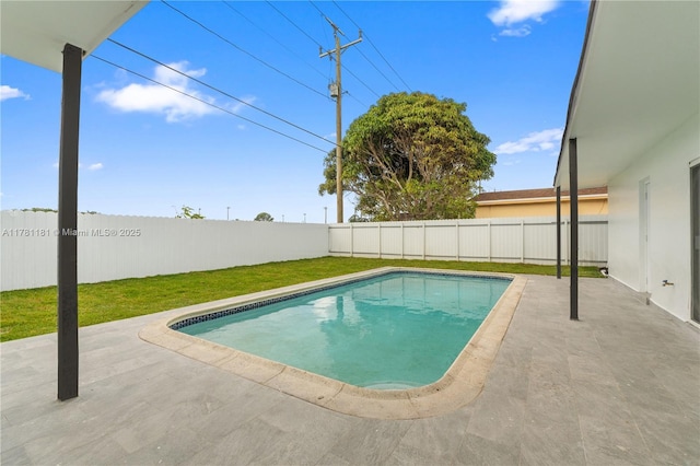 view of swimming pool featuring a patio, a fenced backyard, and a yard