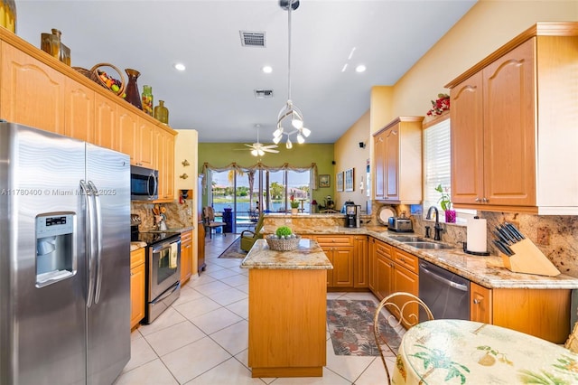 kitchen with stainless steel appliances, plenty of natural light, visible vents, and a sink